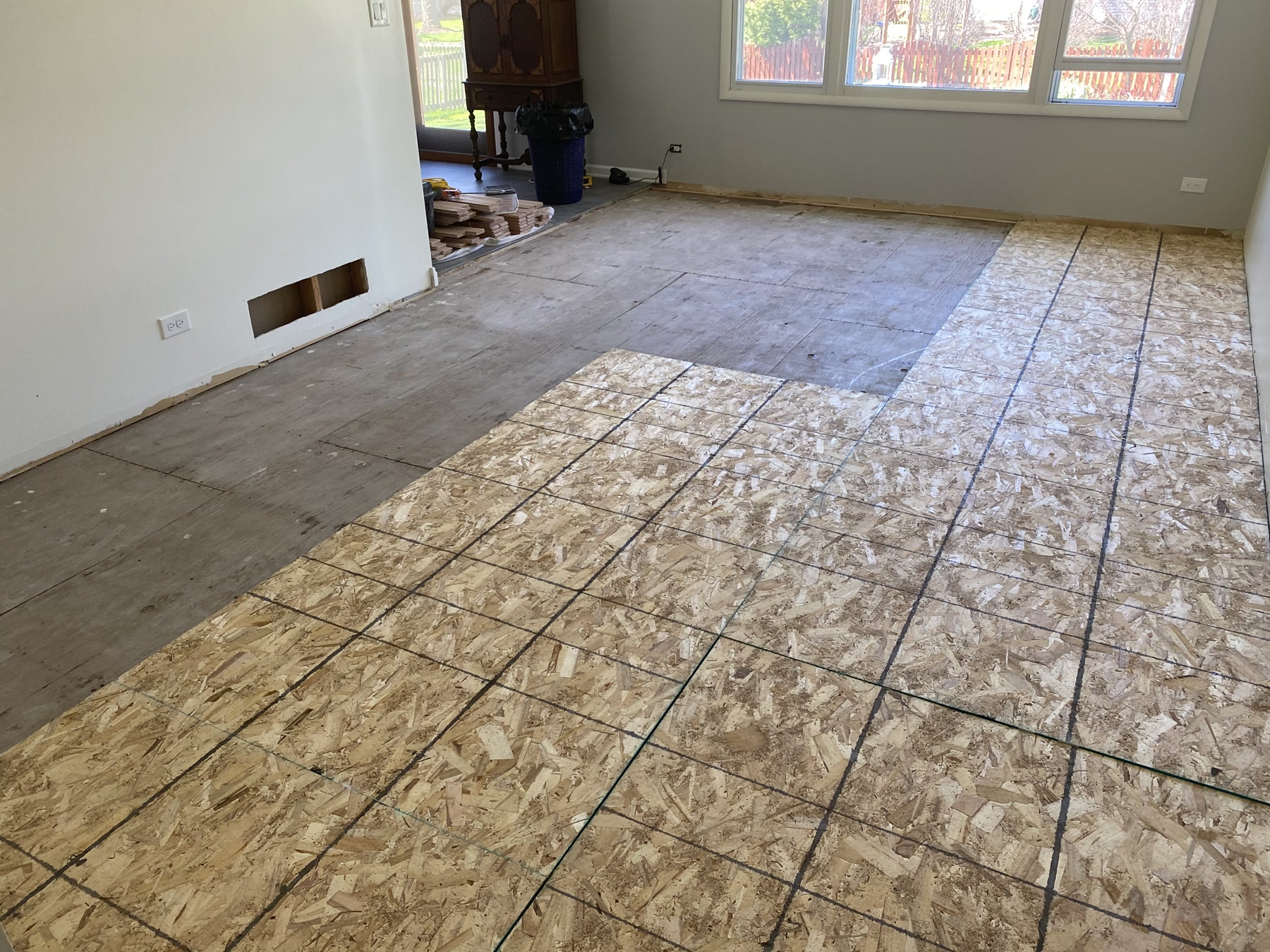 Bare plywood subfloor before the new red oak installation, Naperville, IL