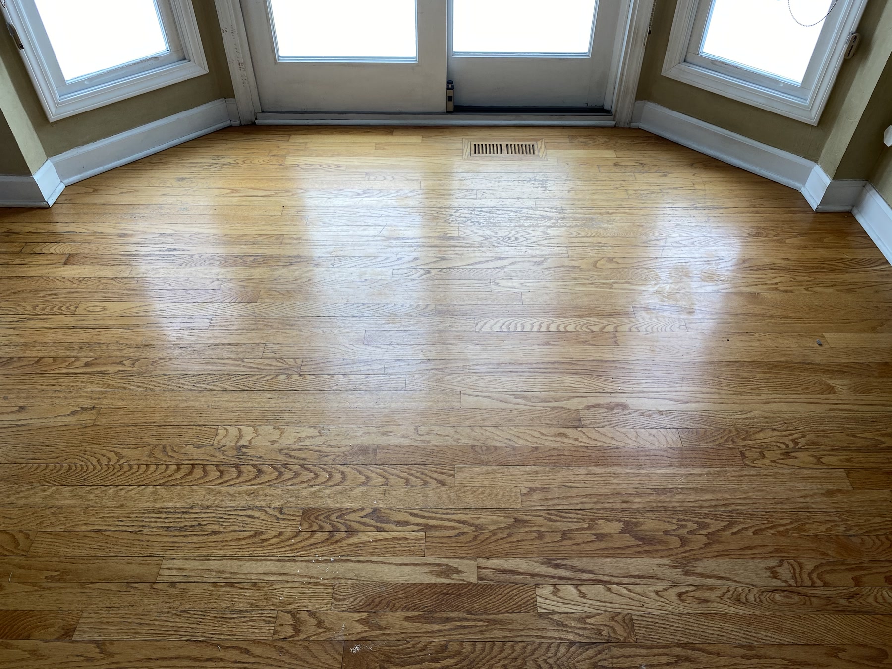 Bare sanded hardwood floor in the bay-window room before Jacobean refinishing, Naperville, IL (in-process)