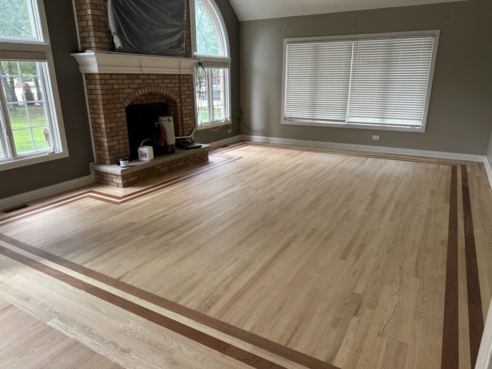 Natural red oak floor with a dark border in the great room, Orland Park, IL