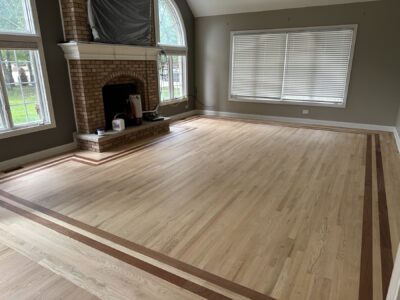 Natural red oak floor with a dark border in the great room, Orland Park, IL