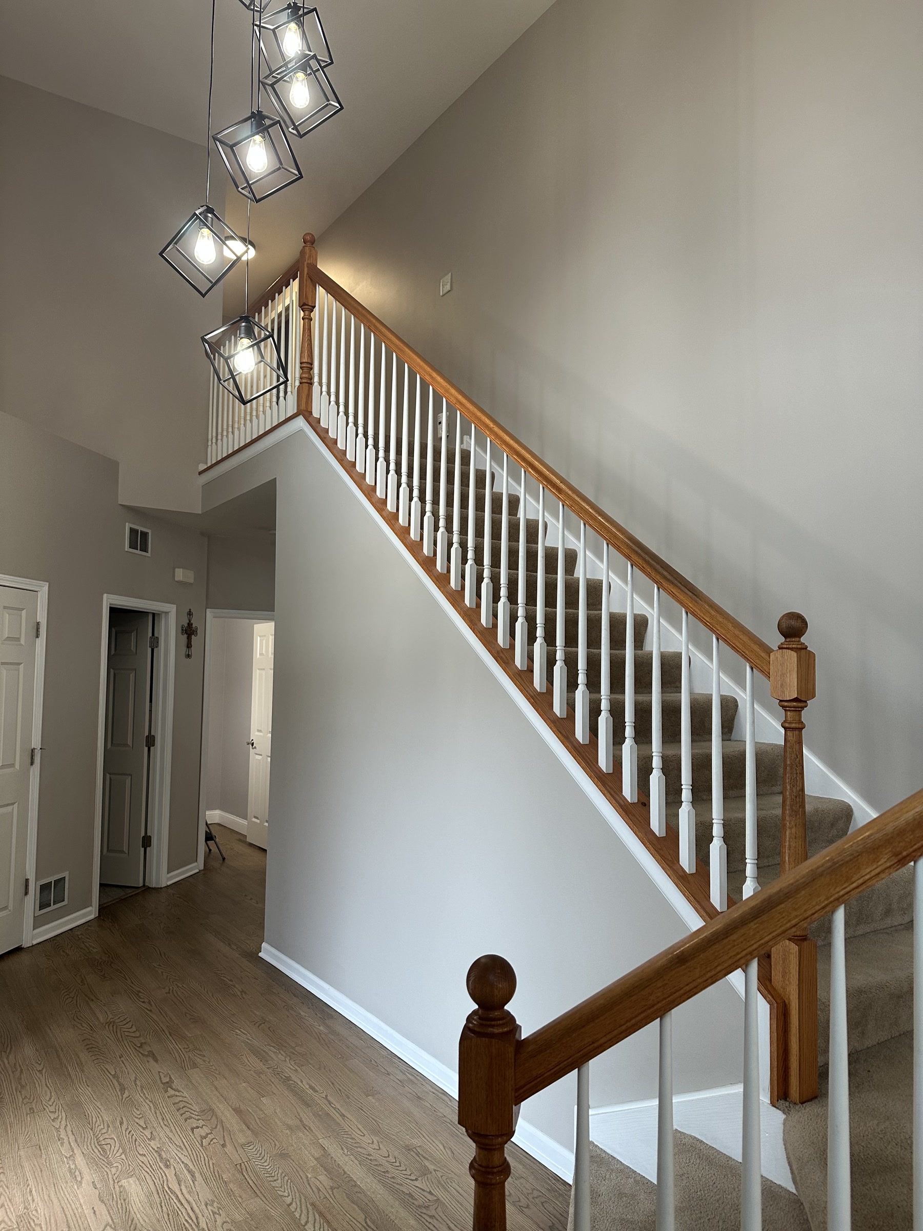 Staircase with the original oak balusters and handrail before replacement, Oswego, IL