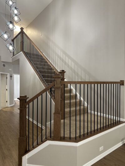 Staircase with new dark newel and black metal balusters, Oswego, IL