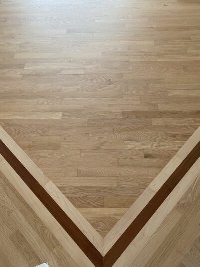Chevron border inlay in the natural hardwood floor, West Chicago, IL