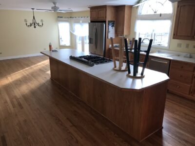 Golden Oak floor by the kitchen island with gas cooktop, Western Springs, IL