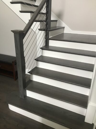 Staircase with dark treads, white risers and a metal railing, Western Springs, IL