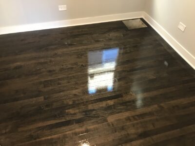 Glossy ebony hardwood floor reflecting daylight, Wheaton, IL