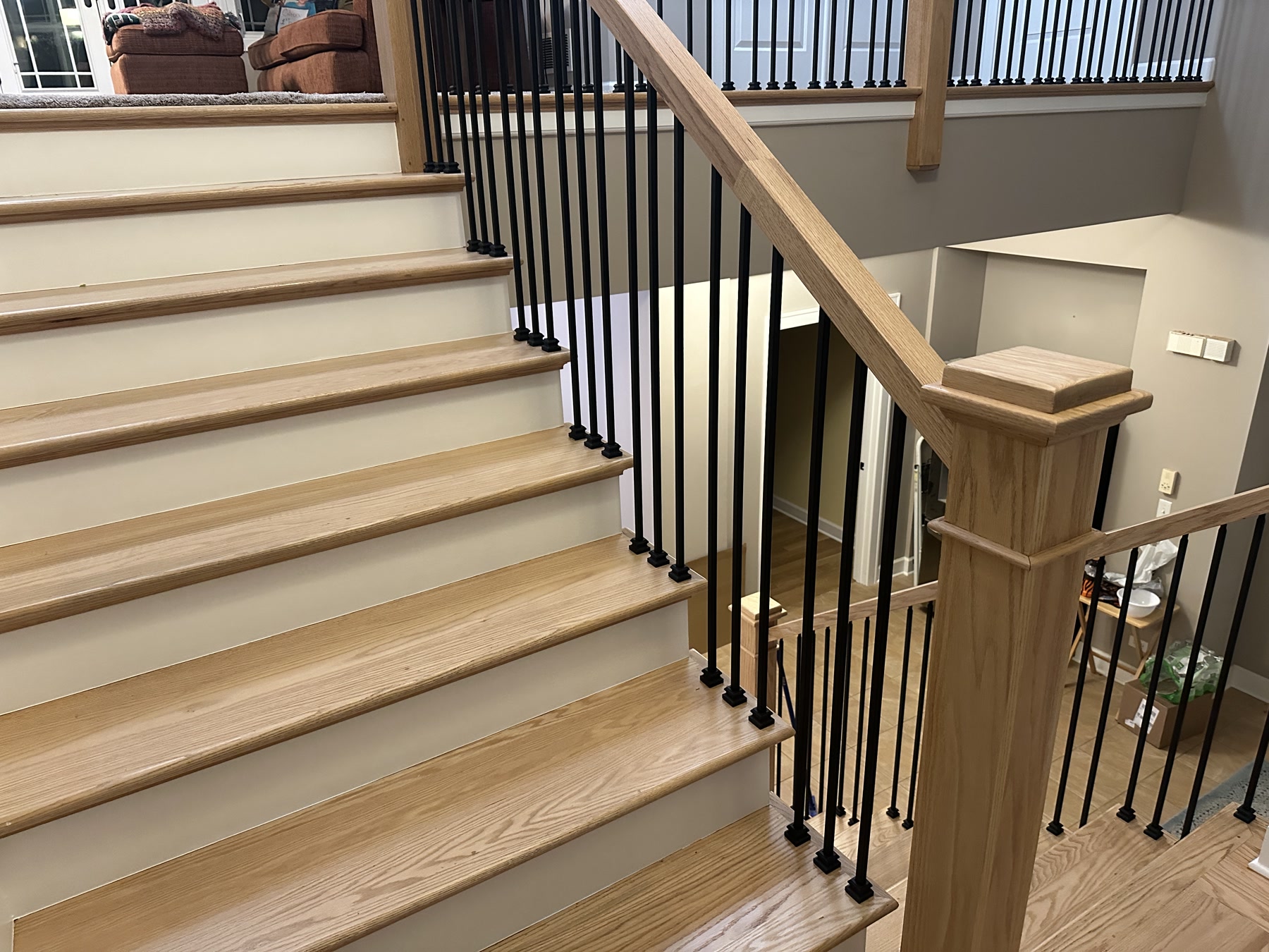 Staircase refinished to white oak treads with black metal balusters, Yorkville, IL