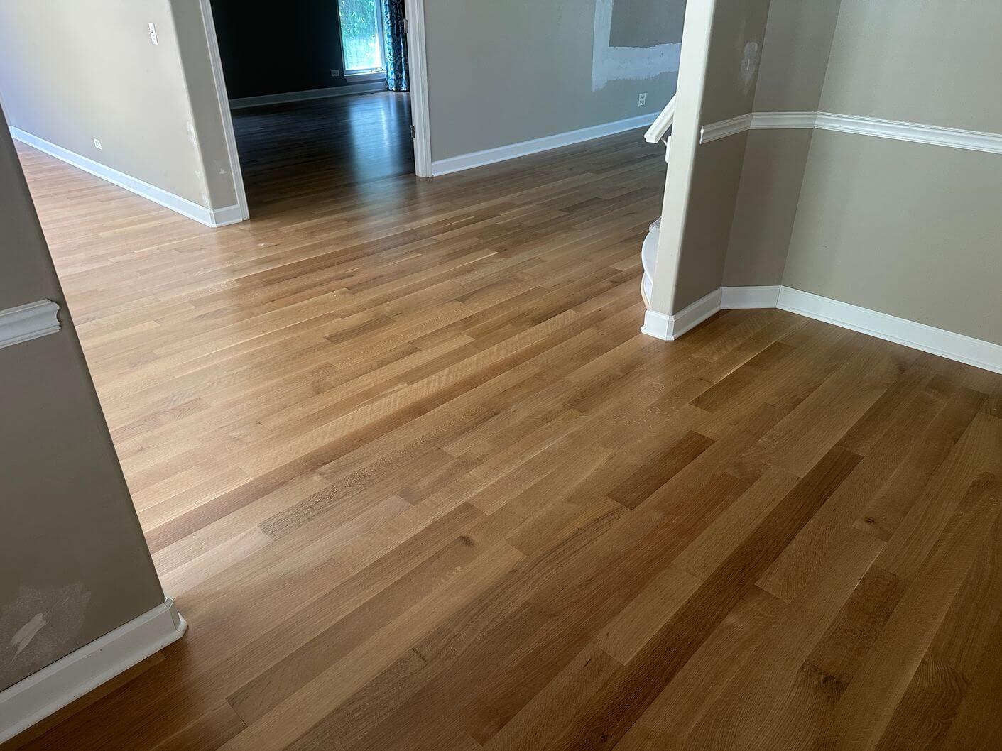 Finished rift and quartered white oak flooring extending through the main living areas of this Aurora home.