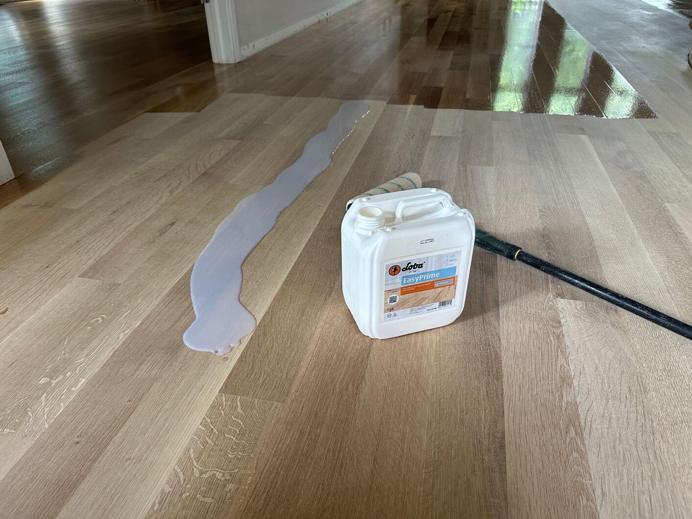 Loba EasyPrime being applied to the natural white oak flooring before the protective finish coats.