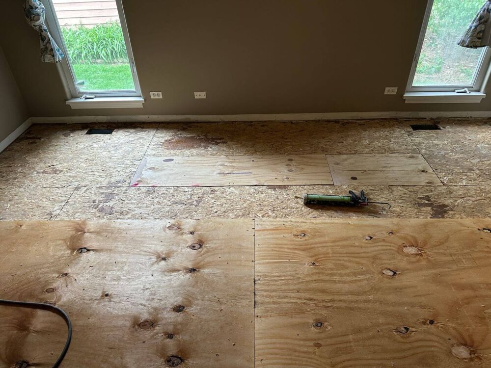 Exposed wood subfloor after removal of the existing flooring and before the new white oak installation.