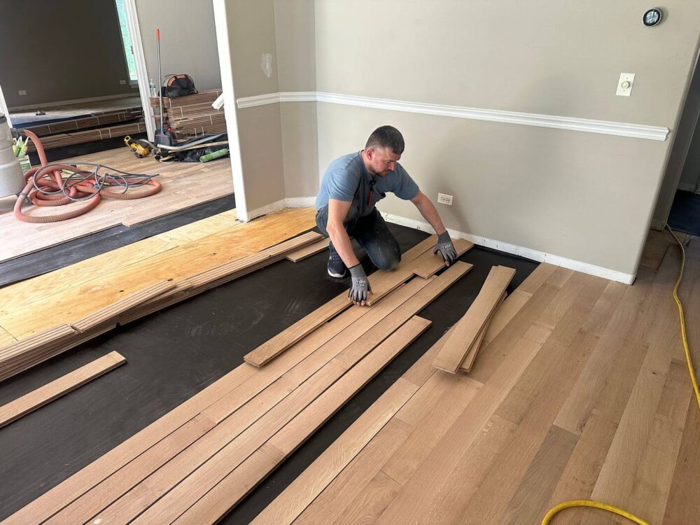 Rift and quartered white oak flooring being installed over moisture-control underlayment.