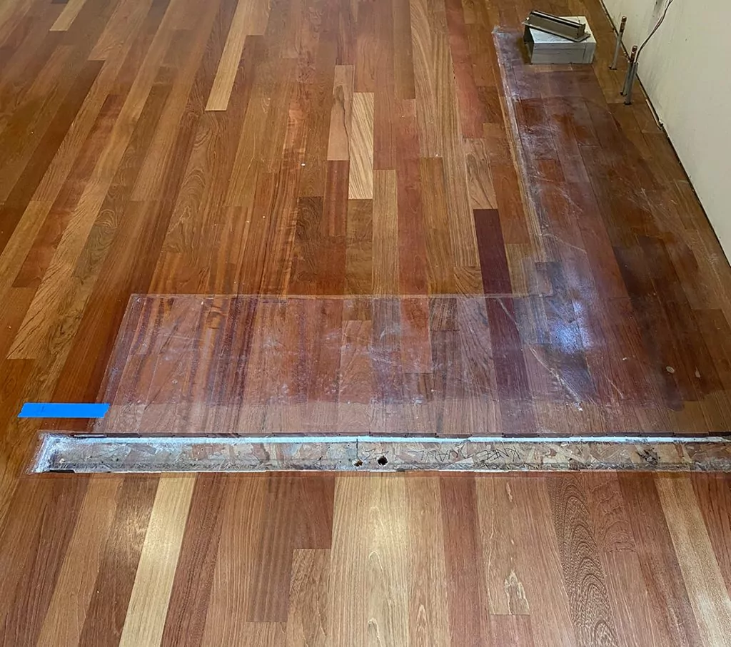 Damaged hardwood floors being repaired