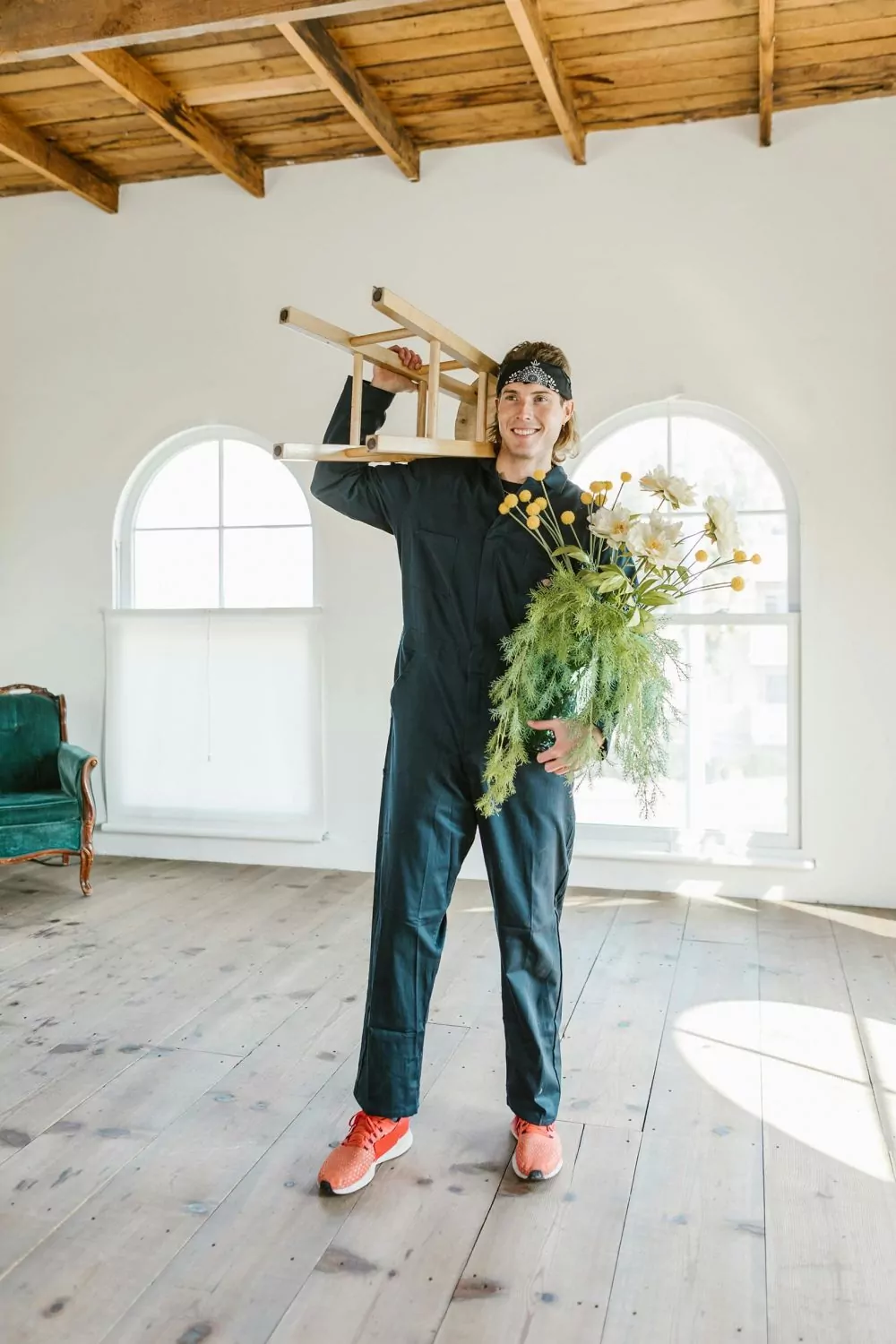 A man removing the furniture before cleaning and polishing the hardwood floor.