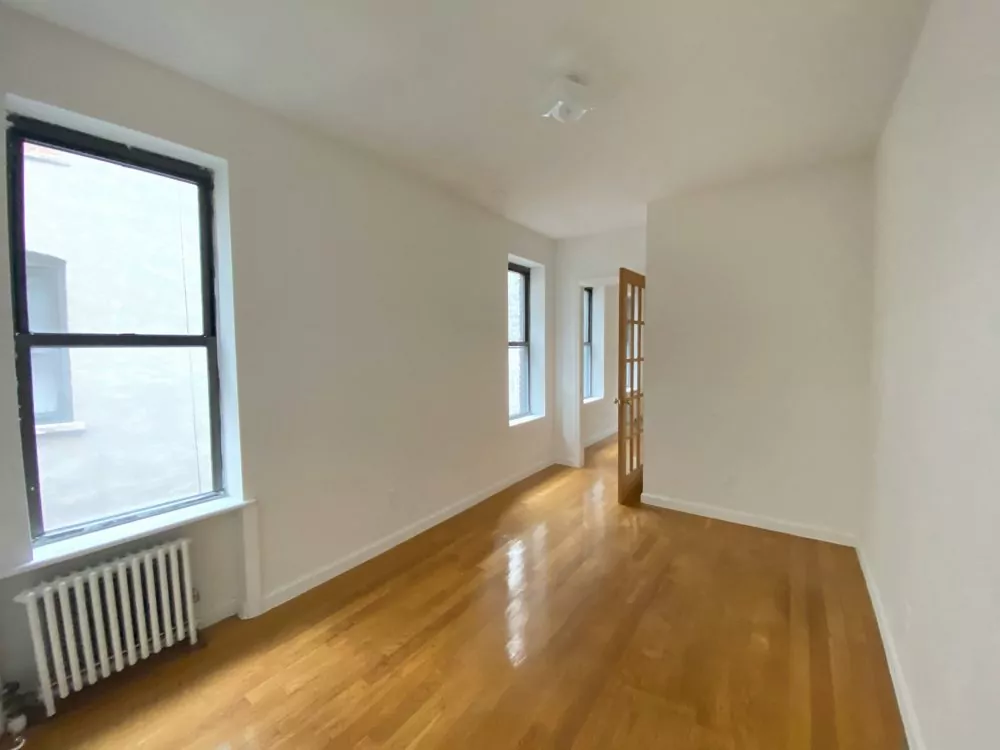 Hardwood floor with visible sheen after being polished with a buffing machine.