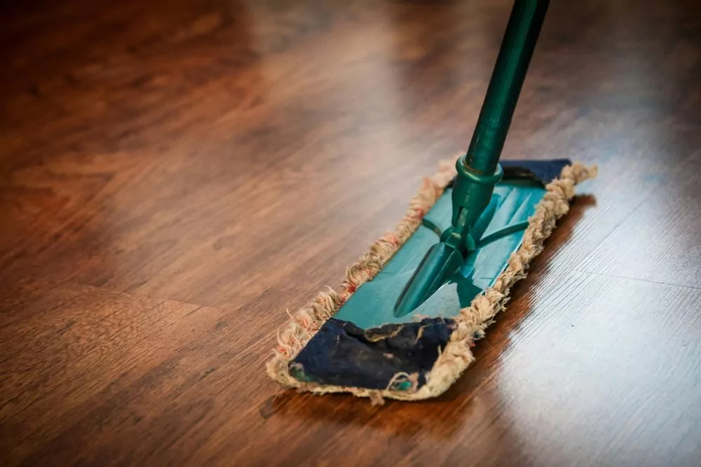 A soft and dry mop used for buffing hardwood floors after cleaning.
