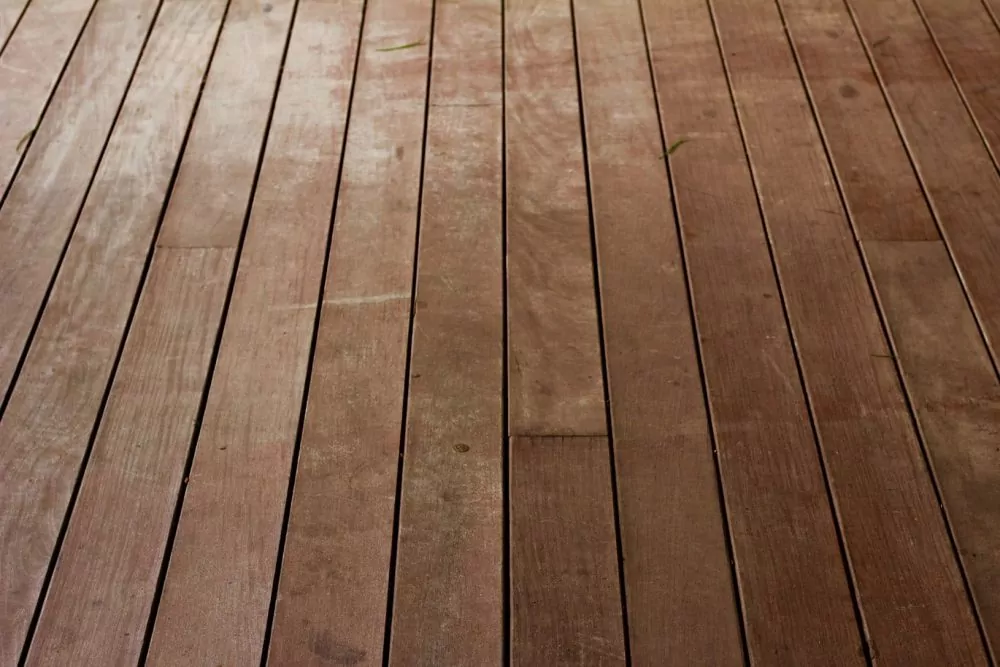 Flooring with visible discoloration, scuffs, and water damage.