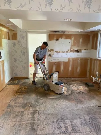A flooring professional from Big Bro Hardwood working on a solid hardwood project.