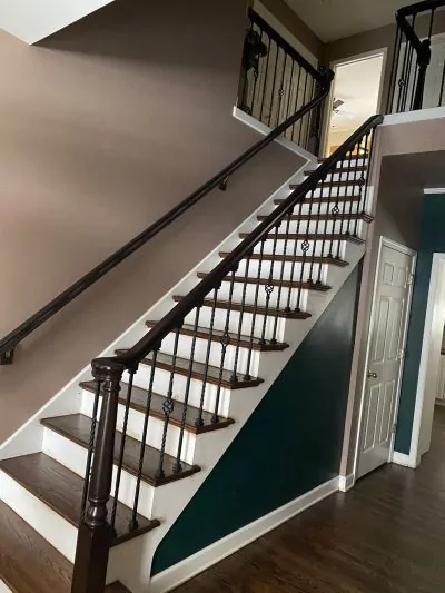 Refinished hardwood staircase with dark-stained oak treads and railing.