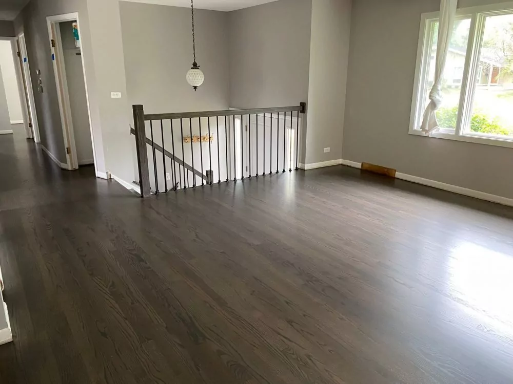 Gray-stained hardwood floor with modern matte wood floor finish.