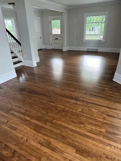 Medium-dark finished hardwood flooring in living room, recent hardwood floor refinishing.