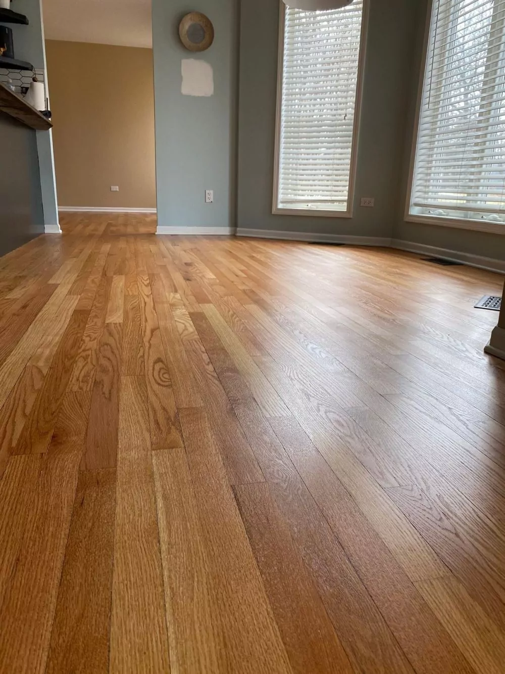 Close view of oak hardwood floors, satin wood floor finish by windows.
